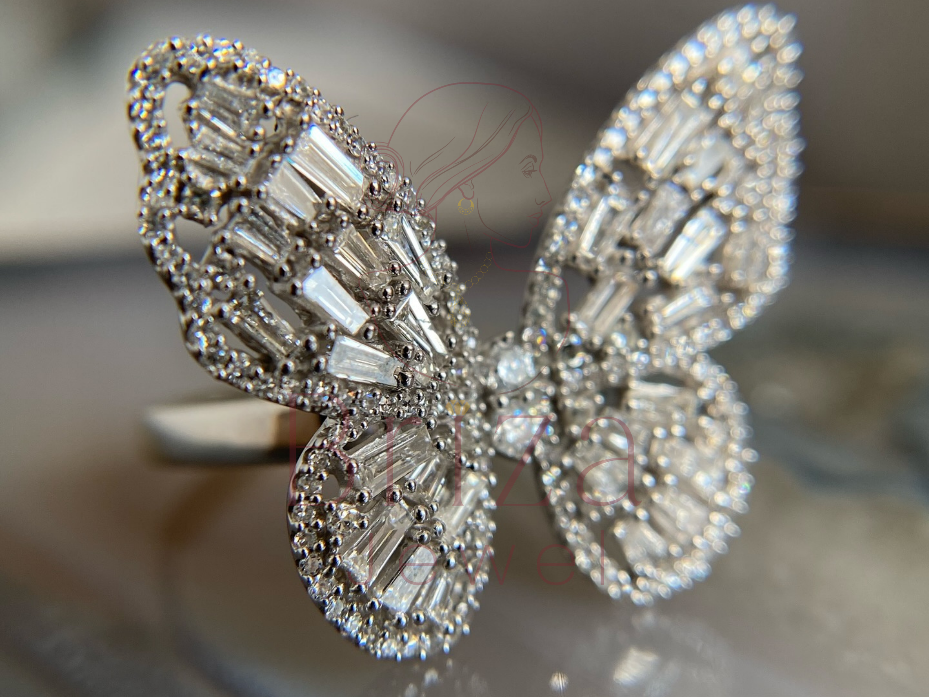 side view of butterfly motif ring in polished metal