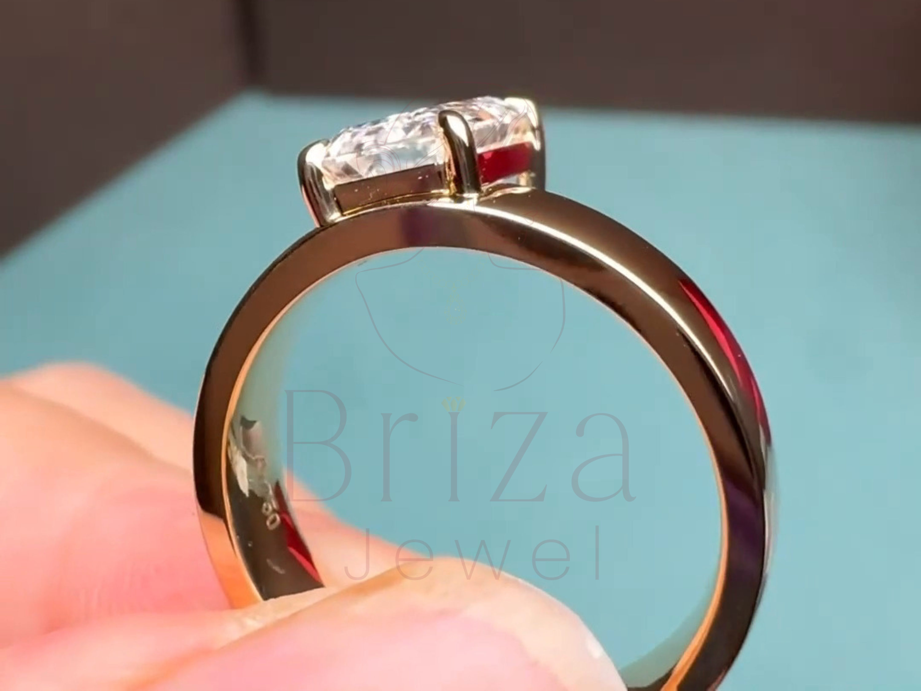 emerald-shaped center stone with art deco gold detailing