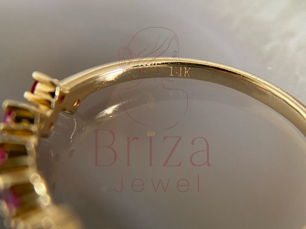 Gold ring with gemstones on a white background with 'Briza Jewel' branding.