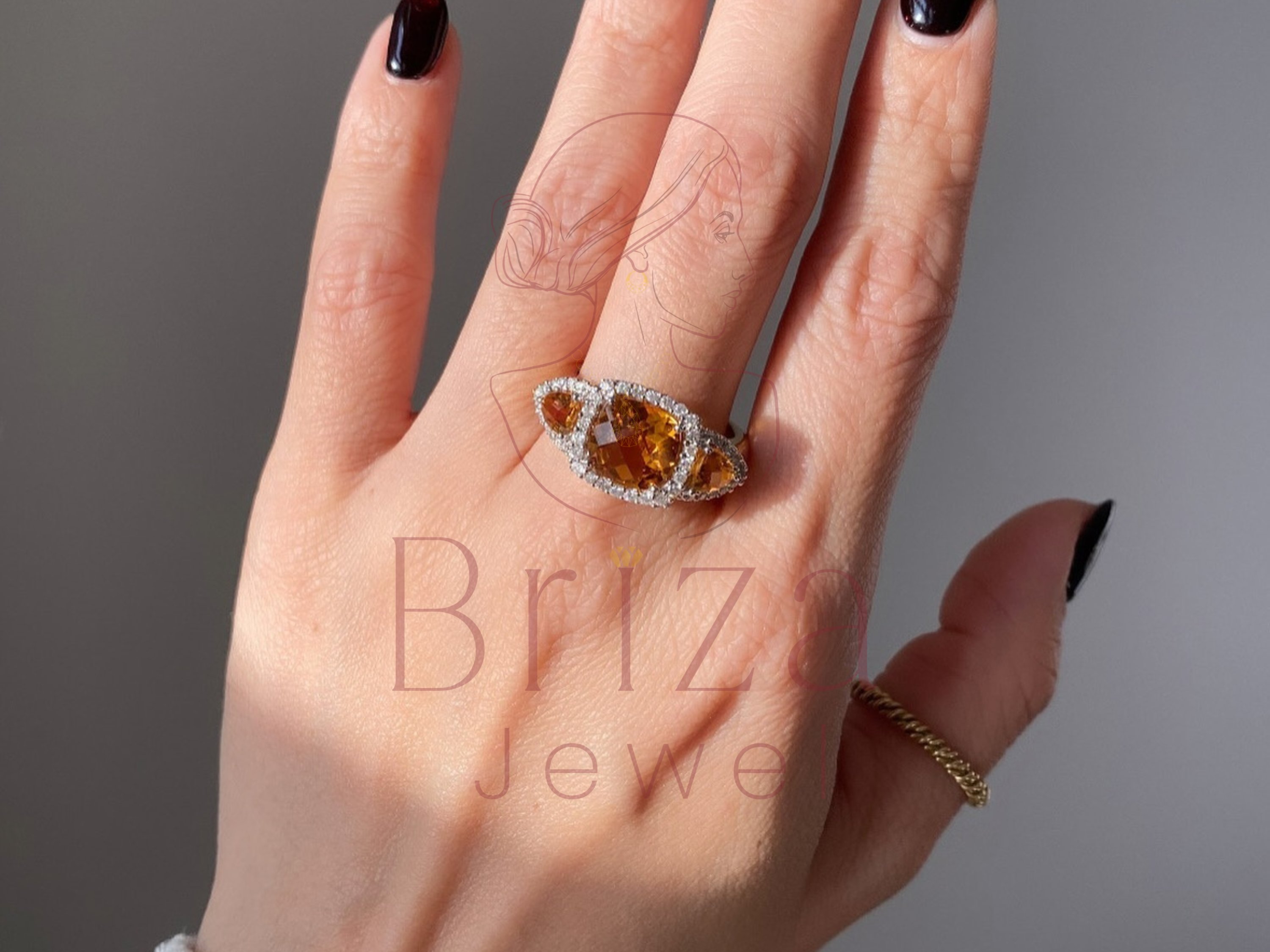 vintage halo tri stone ring with warm yellow gemstone