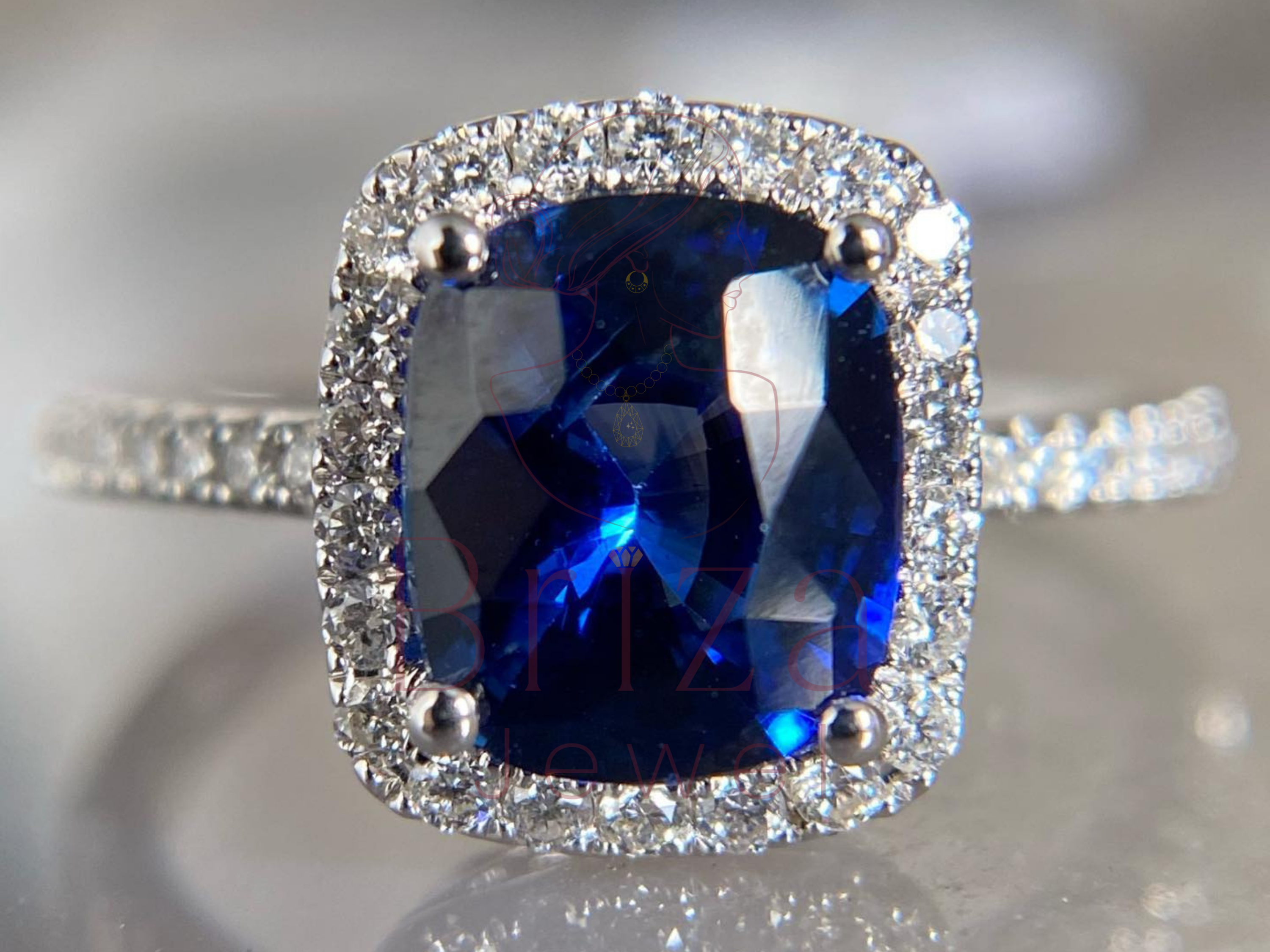 blue sapphire engagement ring with cushion cut halo