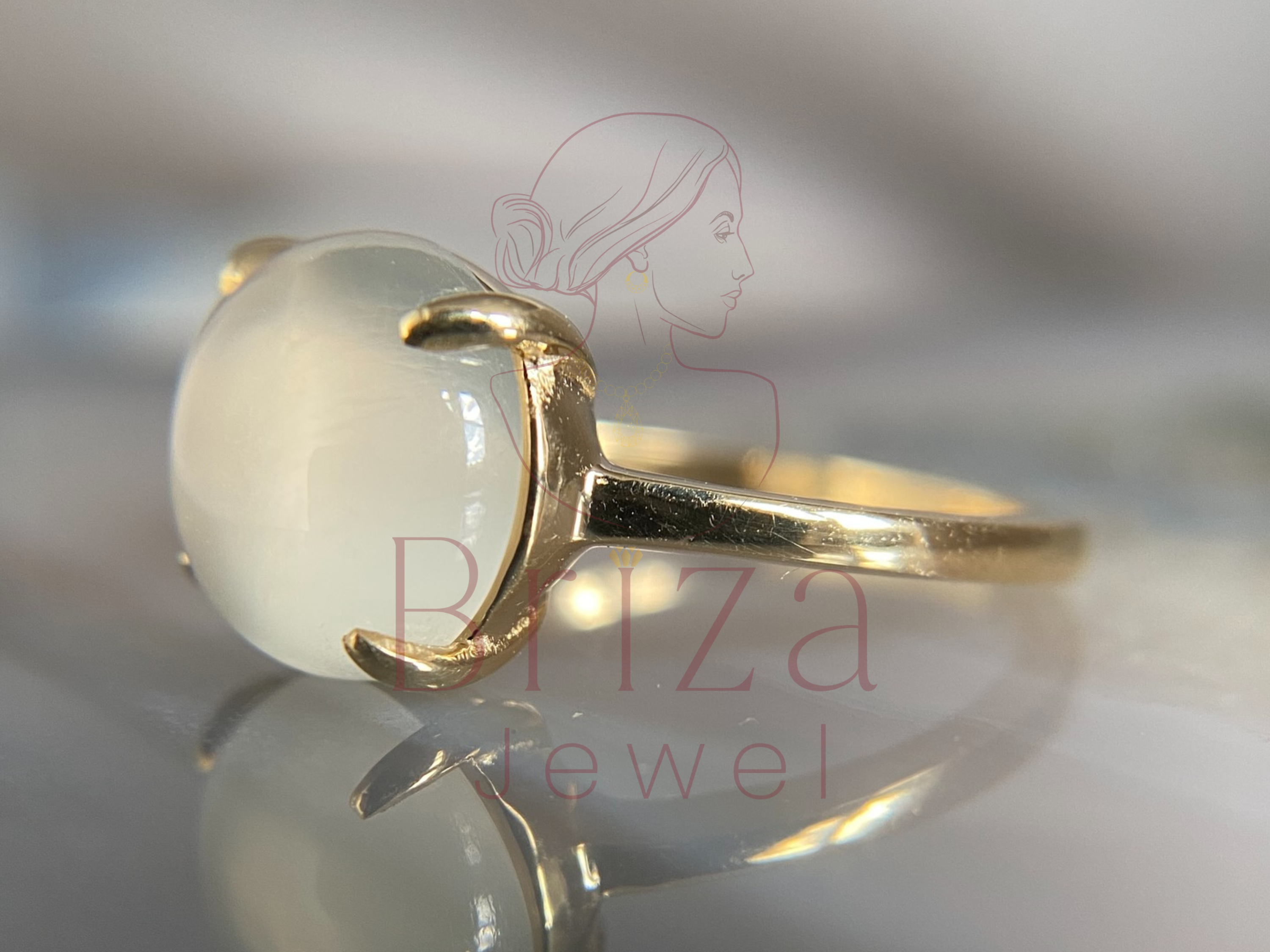 side view of slim gold band with luminous stone setting
