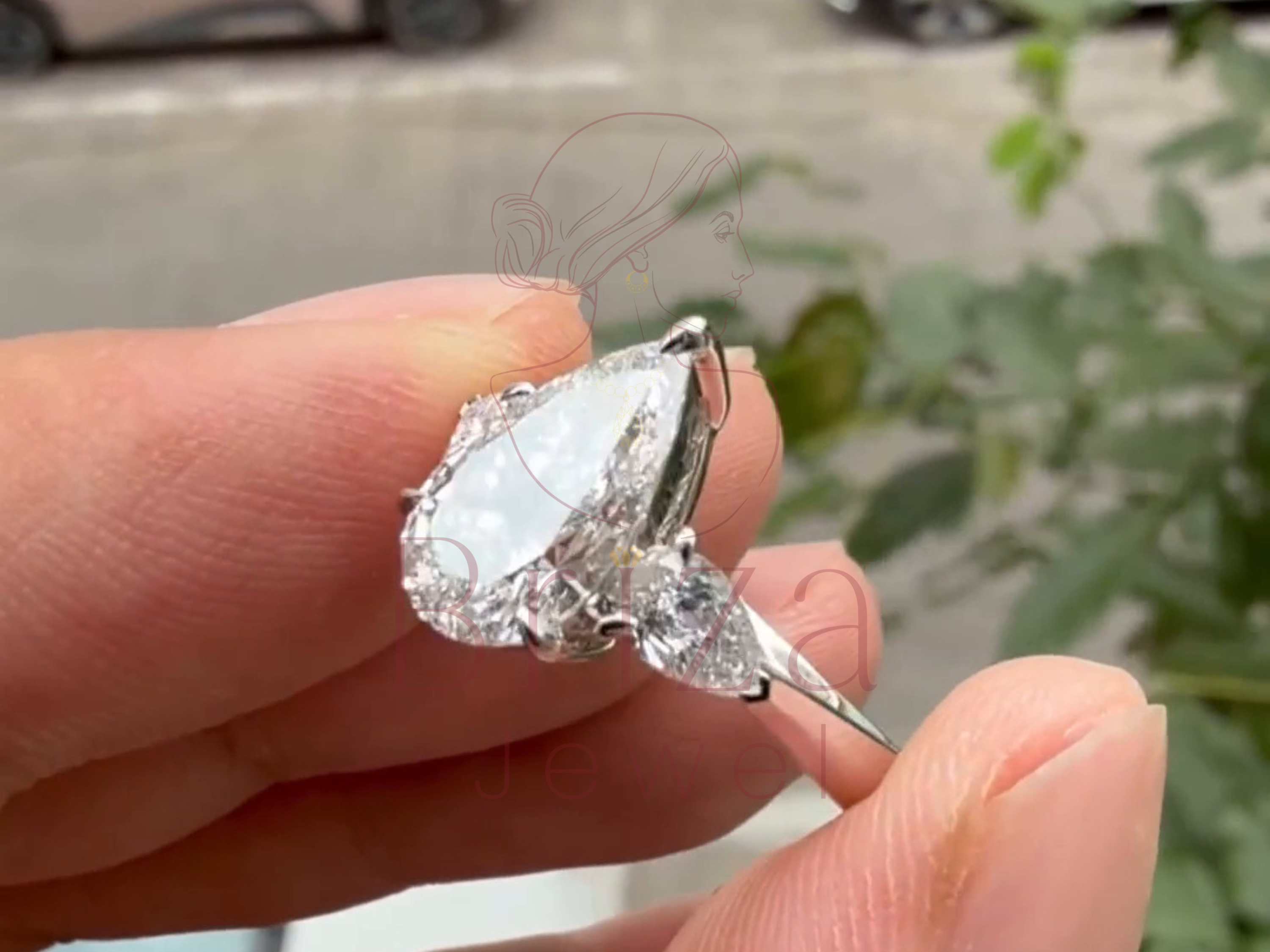 pear-shaped center stone with two side accents