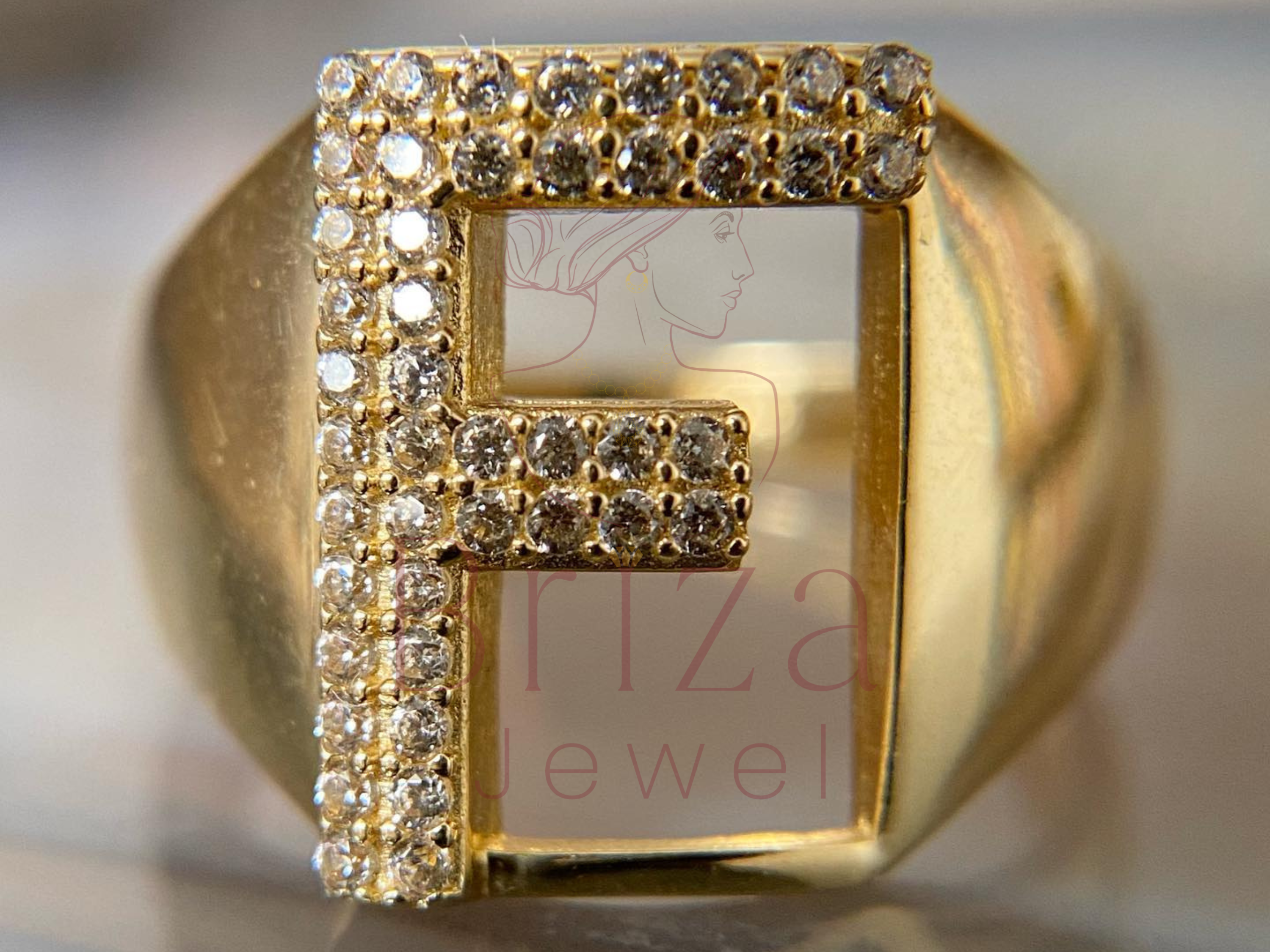 gold ring with initial featuring custom iced out diamond design