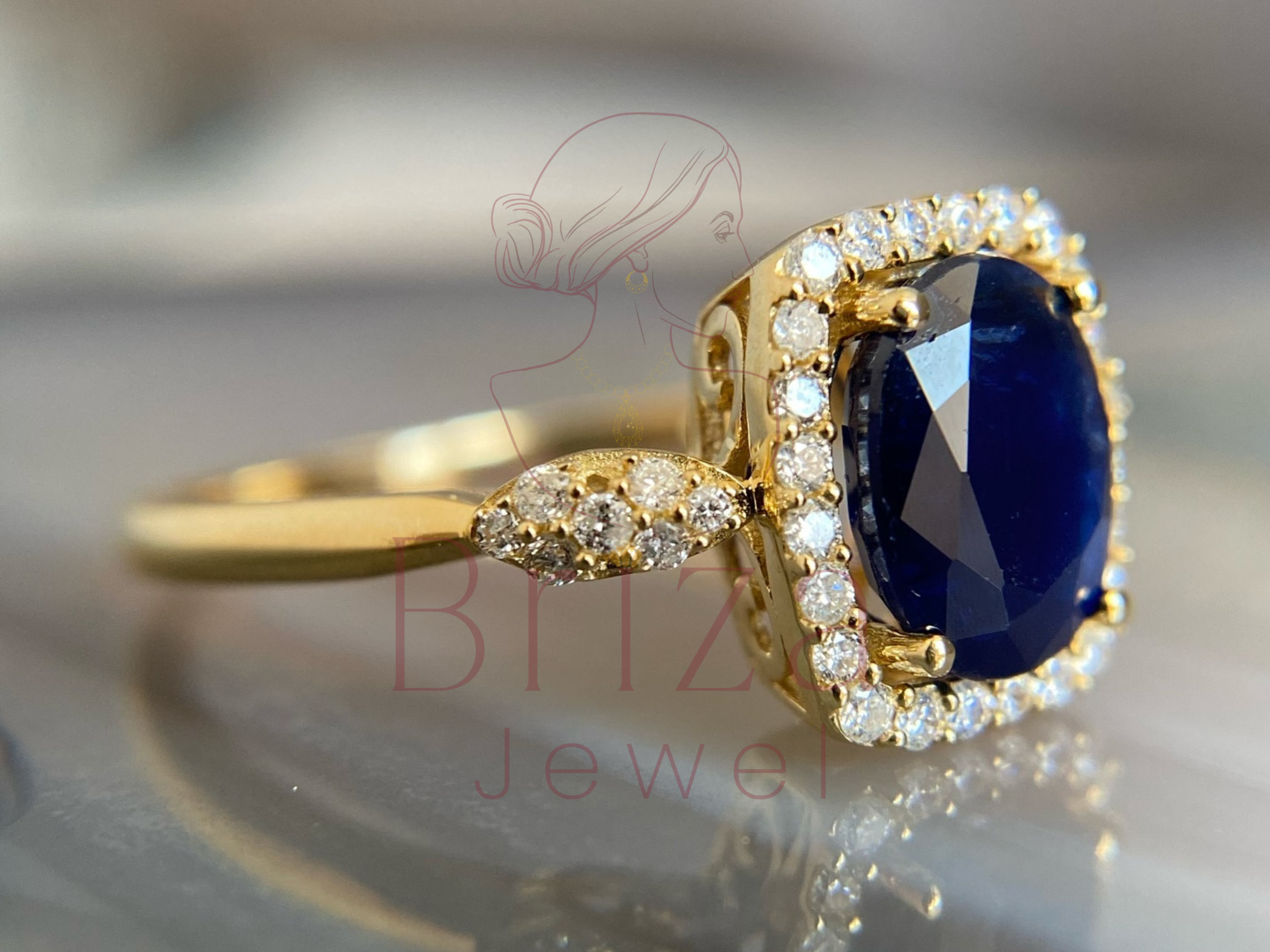 gold engagement ring with sapphire halo worn on hand