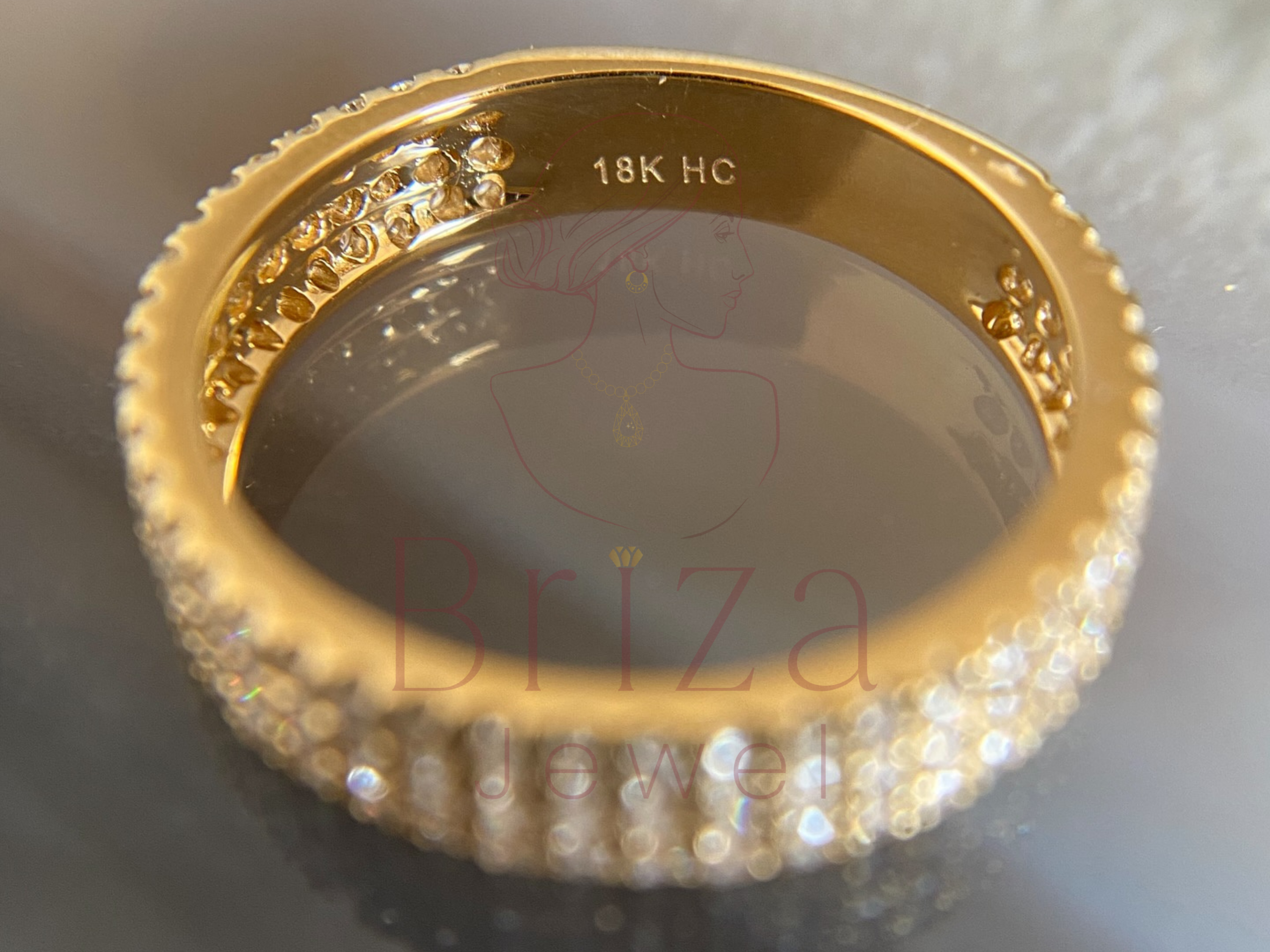 side view of gold ring with multi-row diamond setting