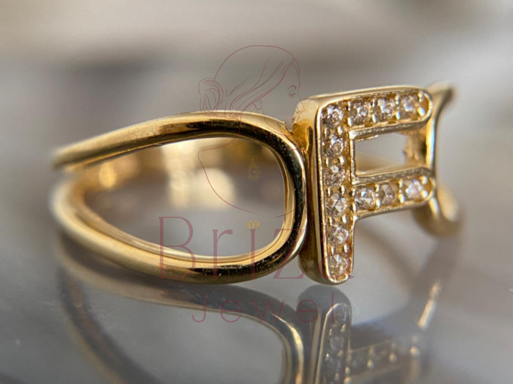 adjustable gold initial ring worn on hand lifestyle view