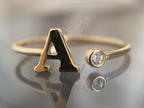 A Gold Ring with Personalized Letter Diamond Design for Women