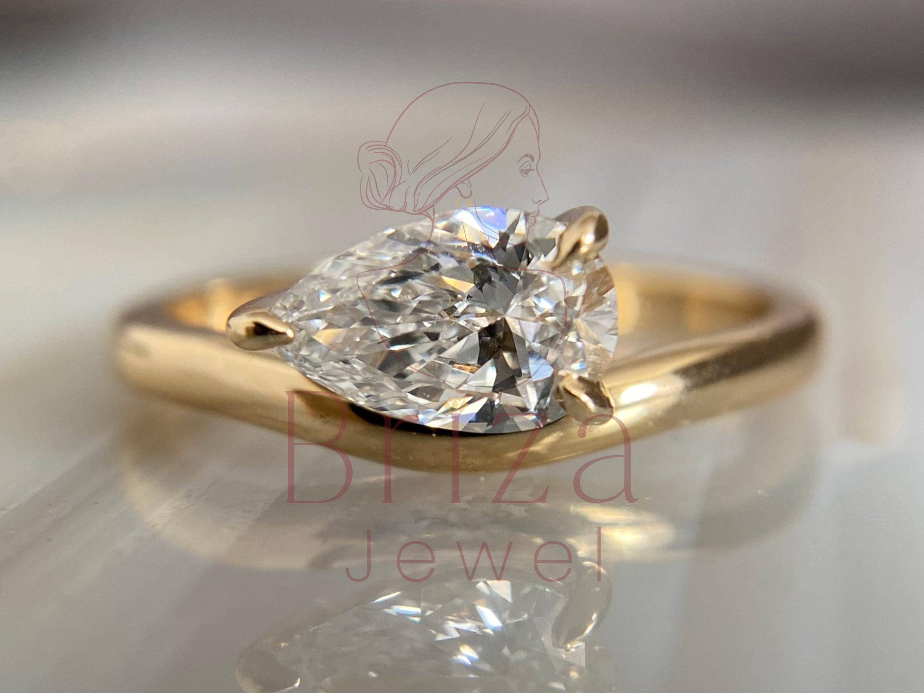pear engagement ring with minimalist teardrop diamond design
