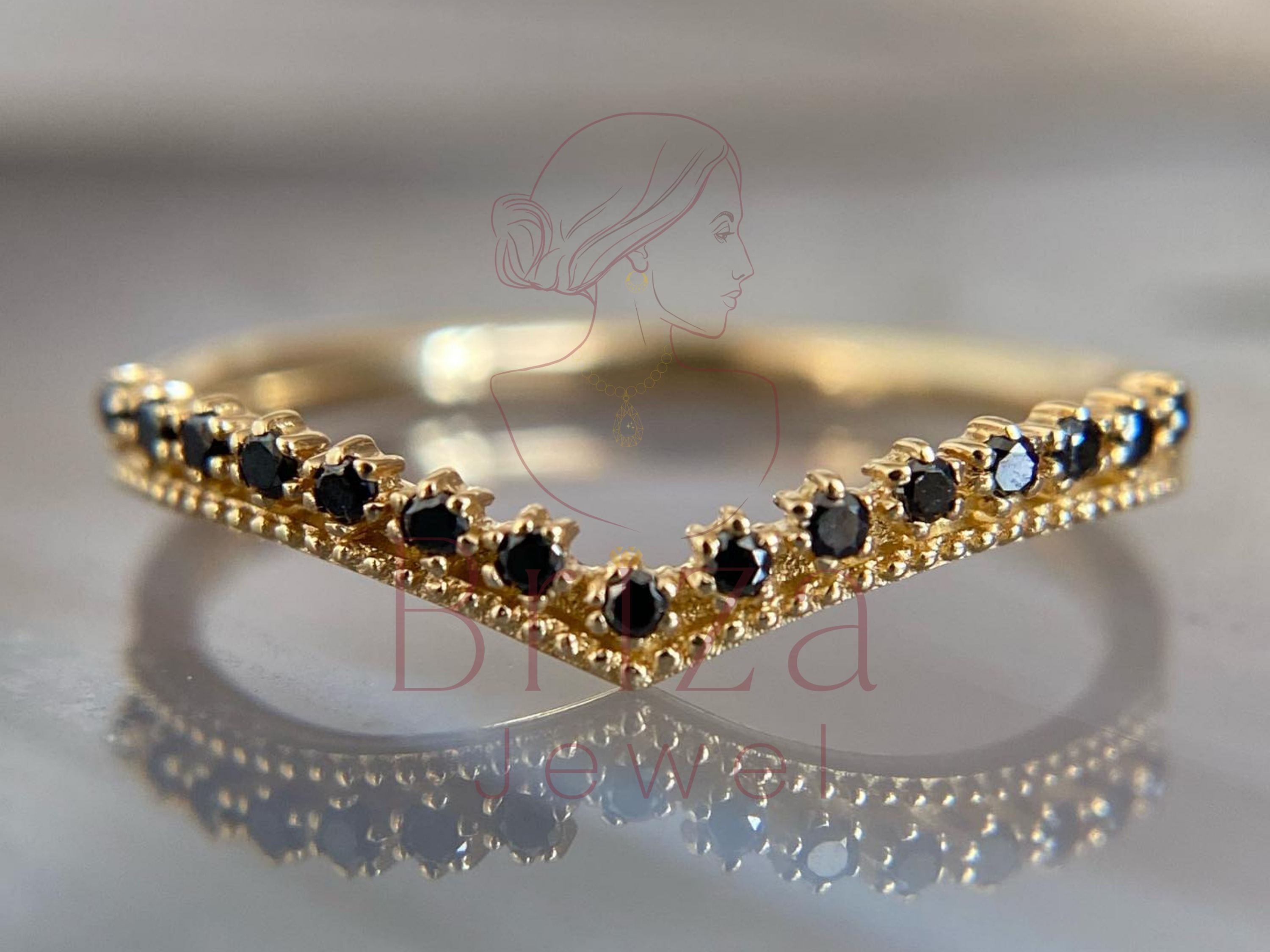 black moissanite ring with gold gothic chevron V stack design