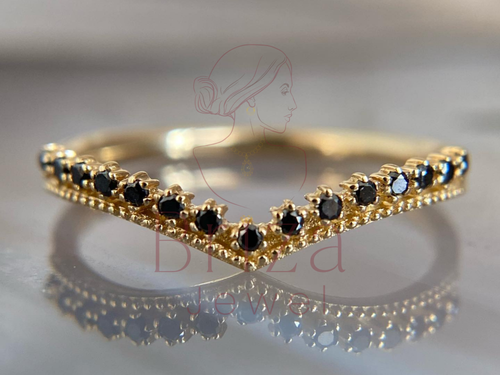 black moissanite ring with gold gothic chevron V stack design