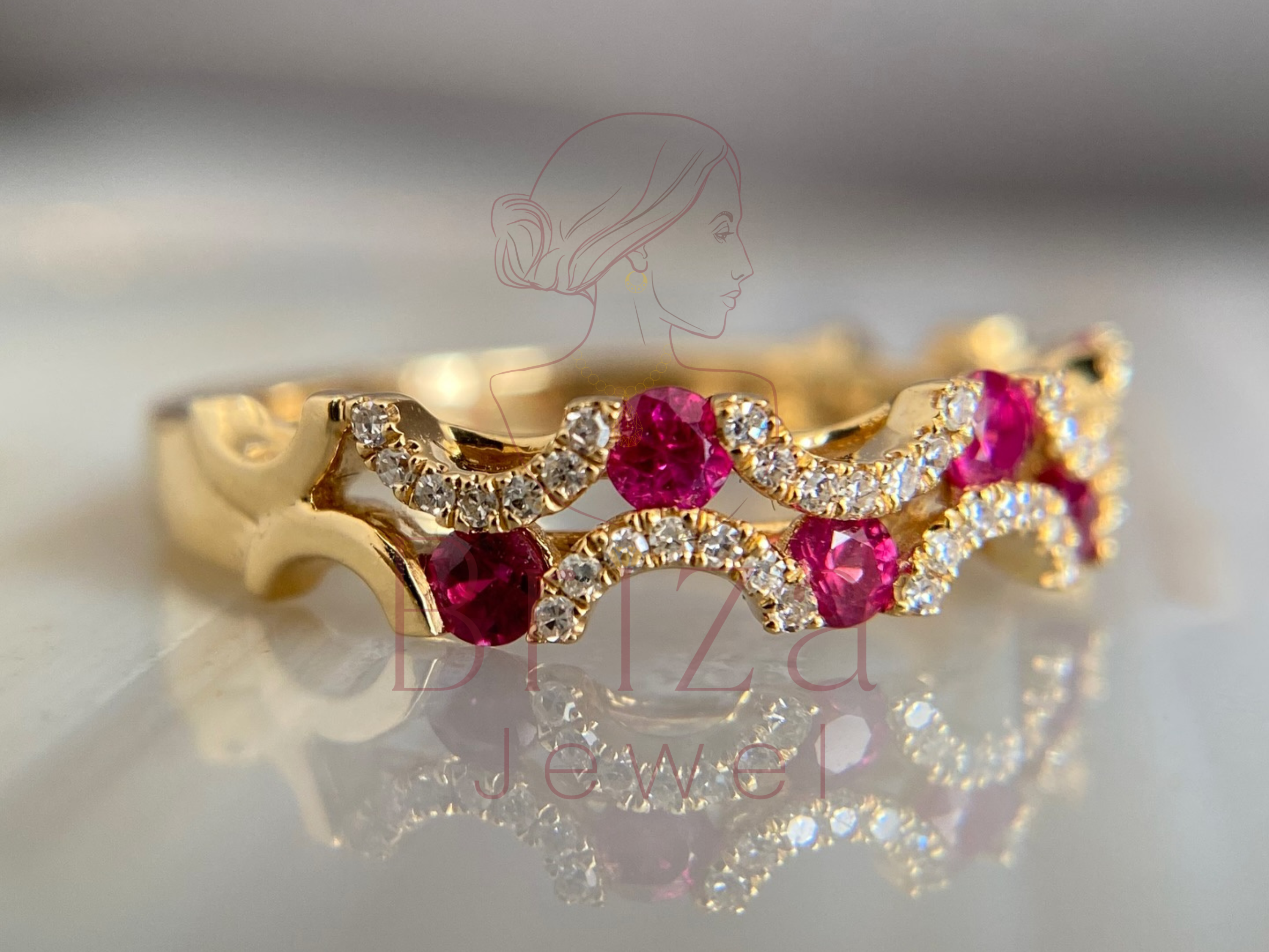 14K gold band with deep red center stone and diamond accents