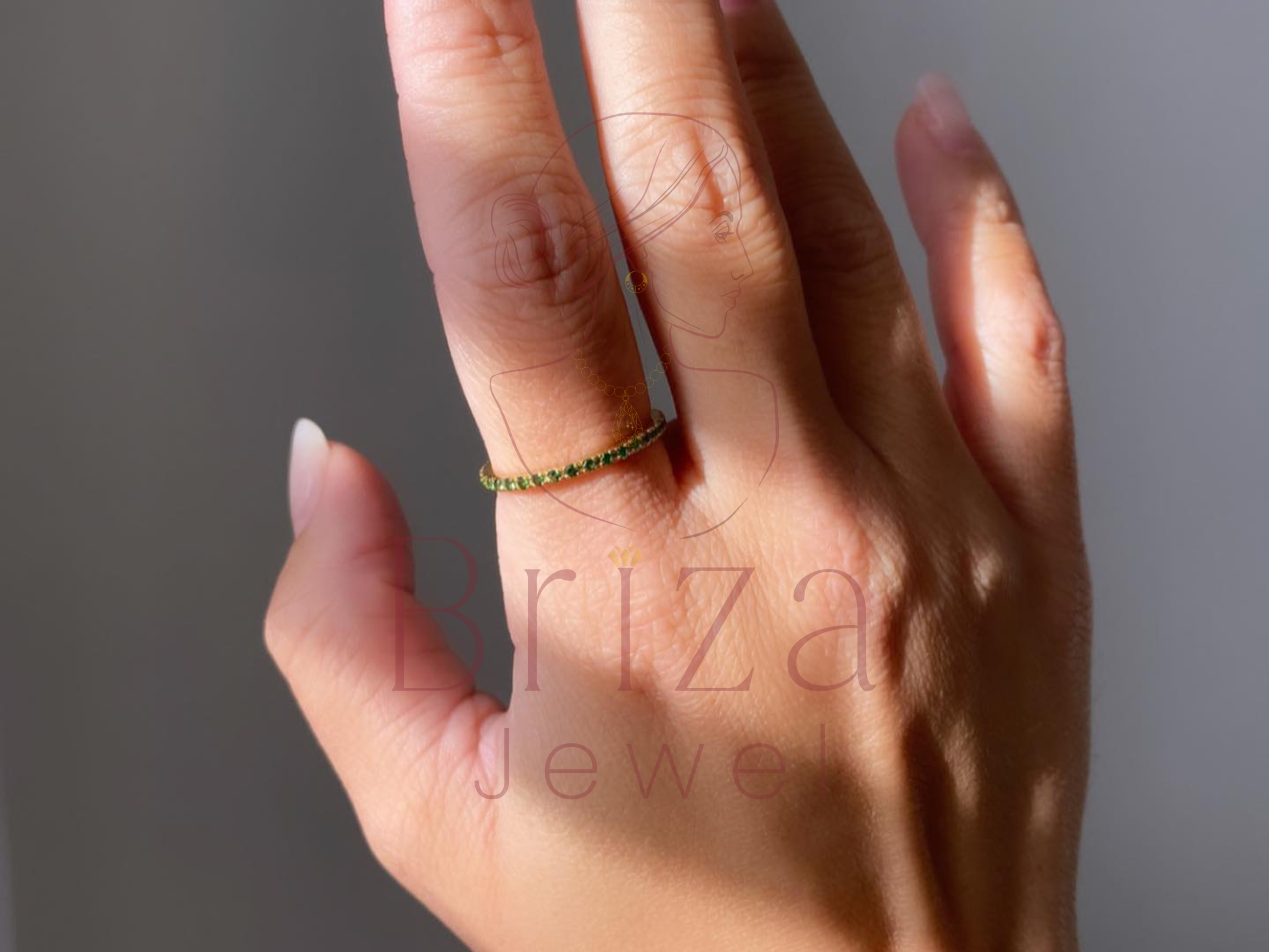 green moissanite engagement ring close-up showing center stone