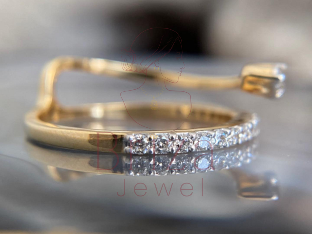 gold bypass design featuring a single solitaire stone