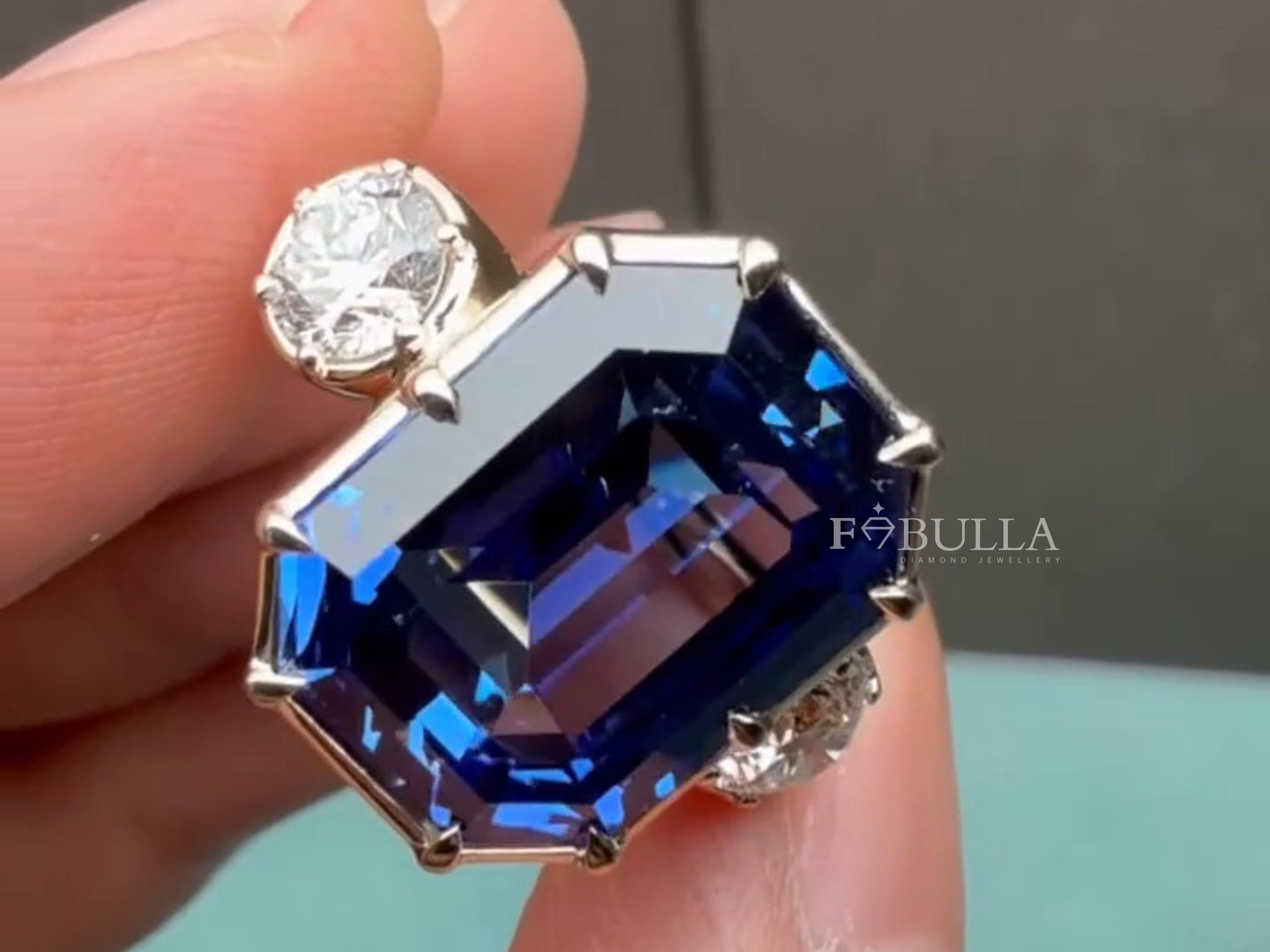 diamond cocktail ring with emerald cut blue sapphire luxury design