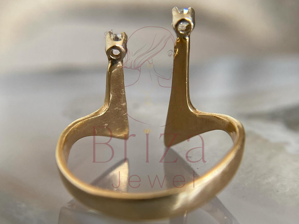 Gold earrings on a stand with 'Biza Jewel' branding.