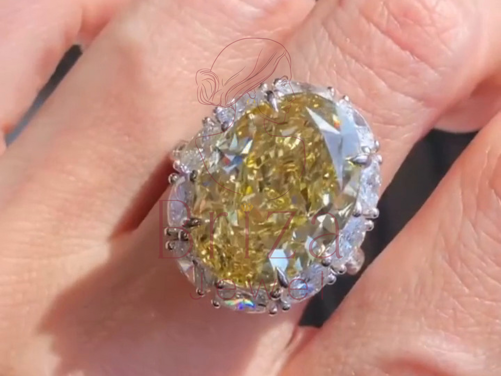 yellow oval center stone surrounded by sparkling halo accents