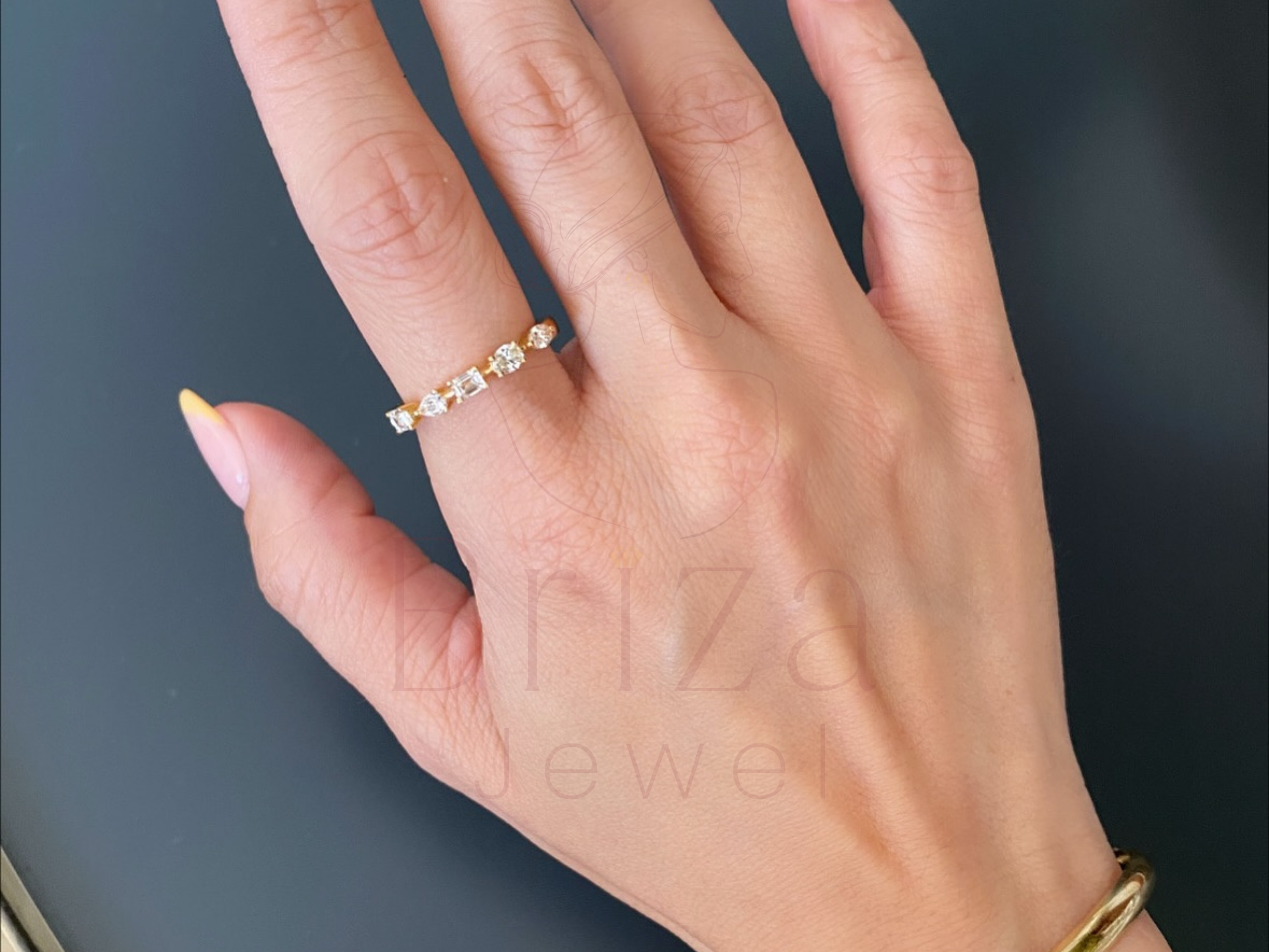 close-up of round diamonds set in an 18K gold band