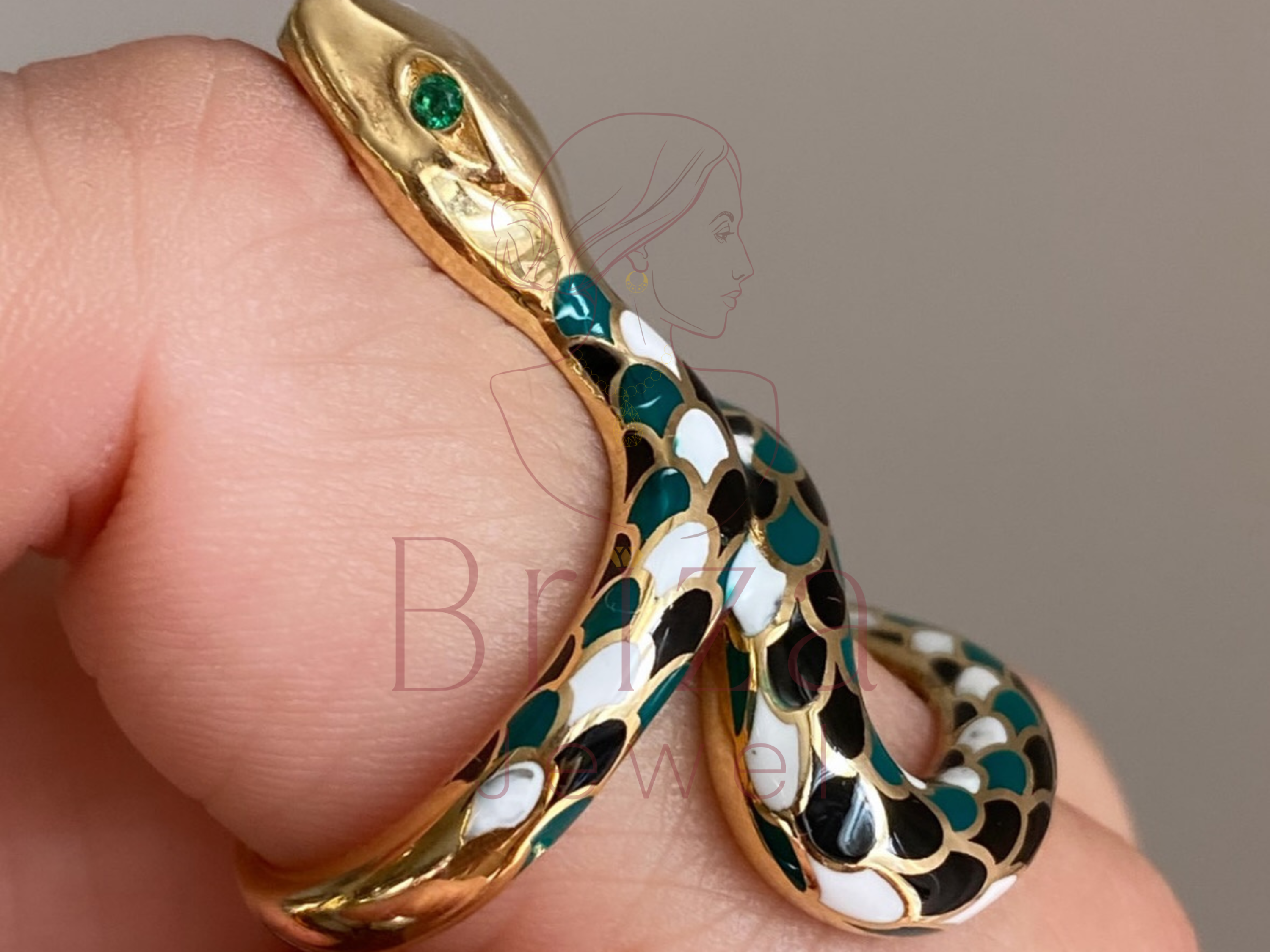 coiled gold jewelry design with colorful enamel accents