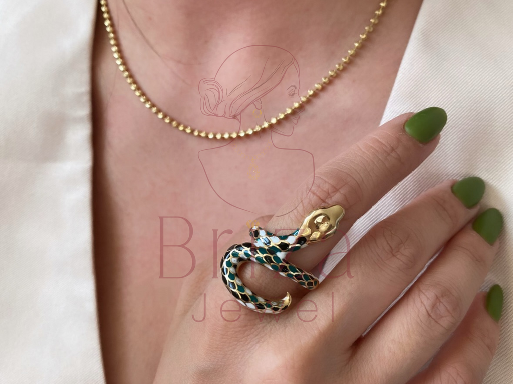 ring snake gold close-up showing enamel serpent detail