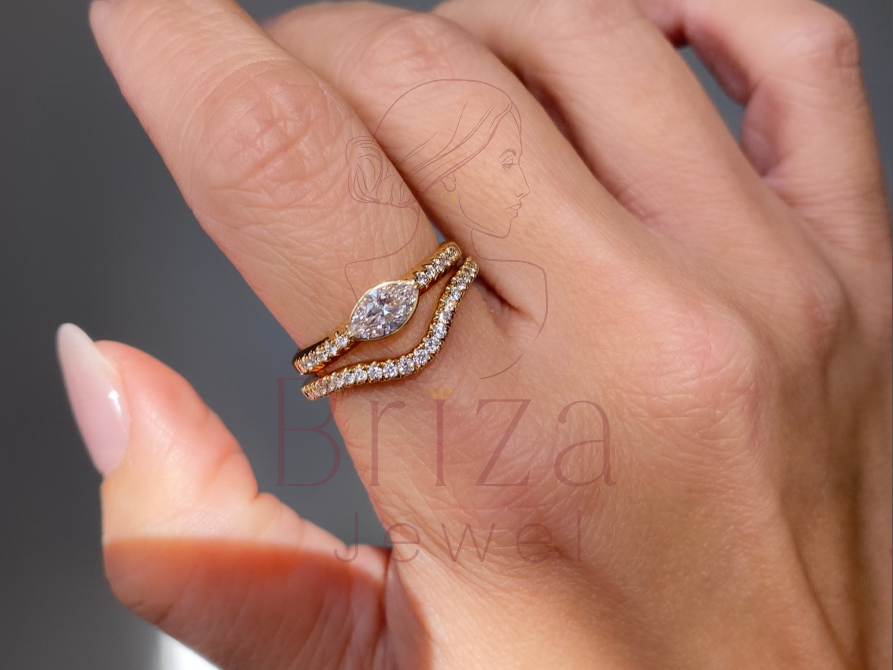 elongated center stone set on a yellow gold band