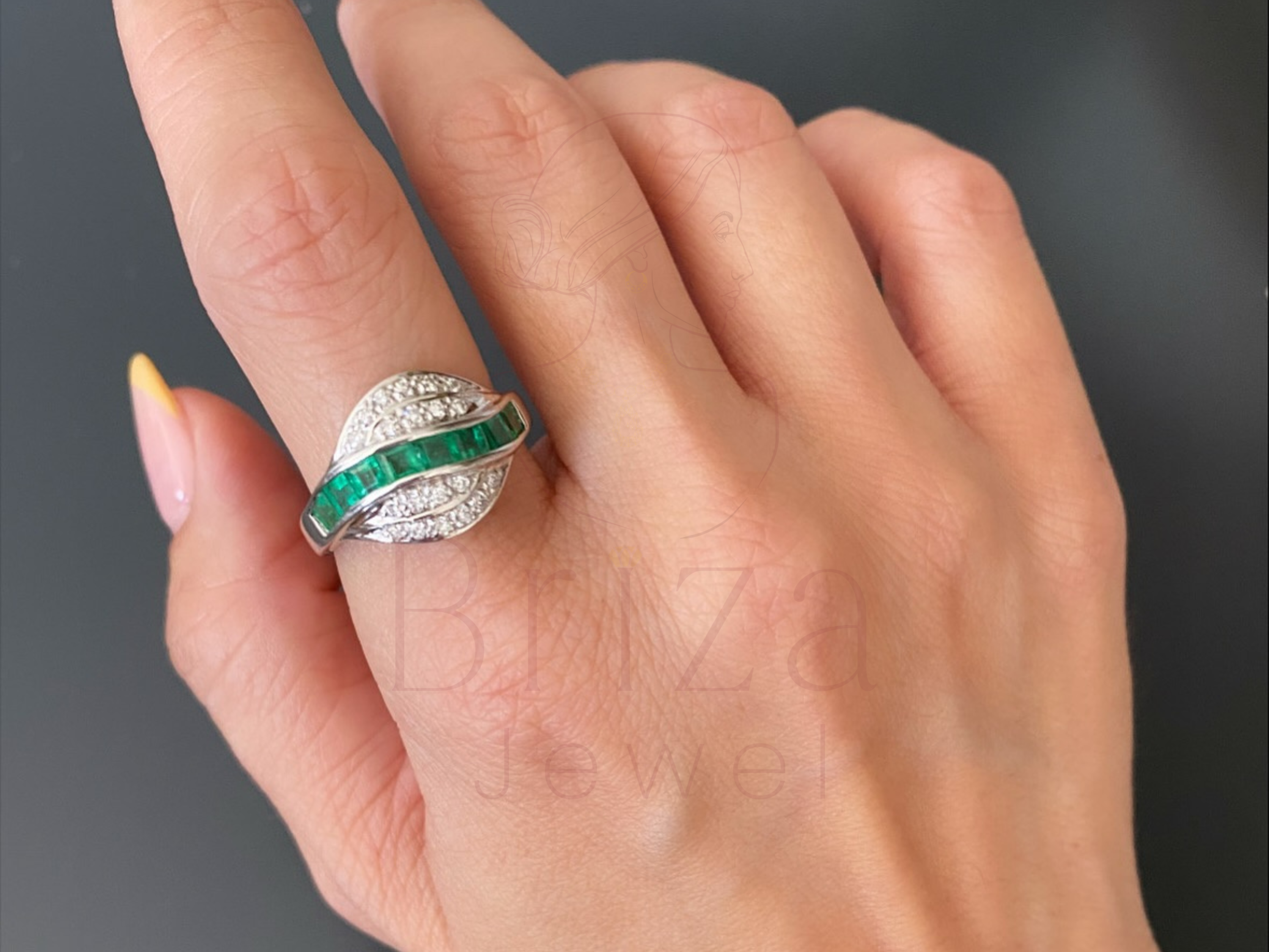 cocktail diamond ring close-up showing emerald and diamond detail