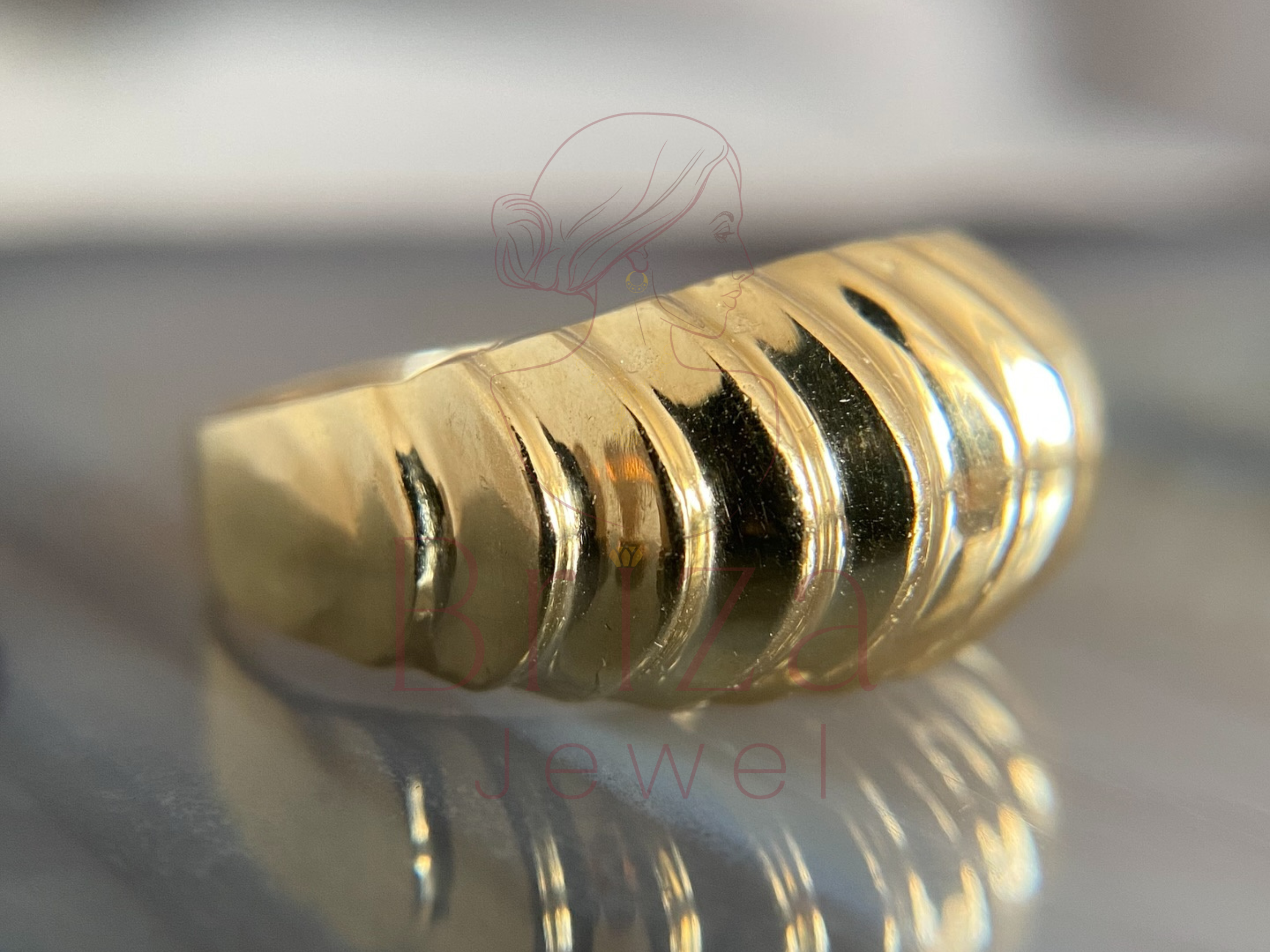 elegant textured gold jewelry worn on hand lifestyle view