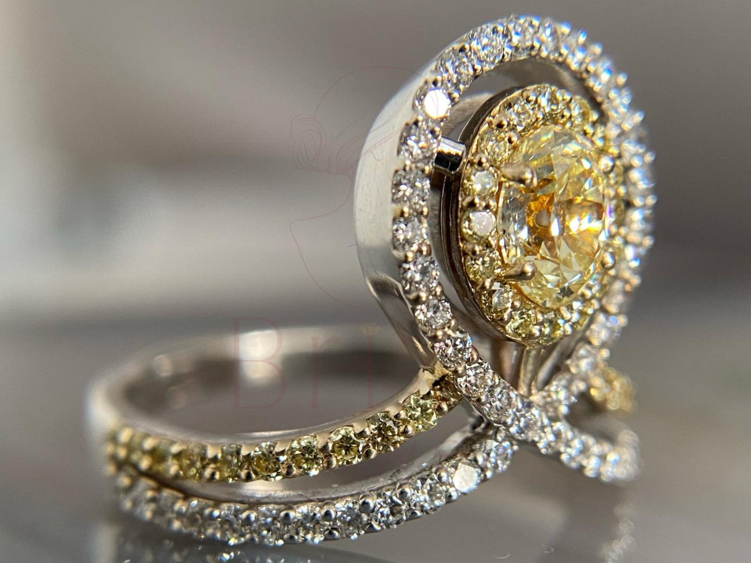yellow center stone surrounded by halo in split shank setting