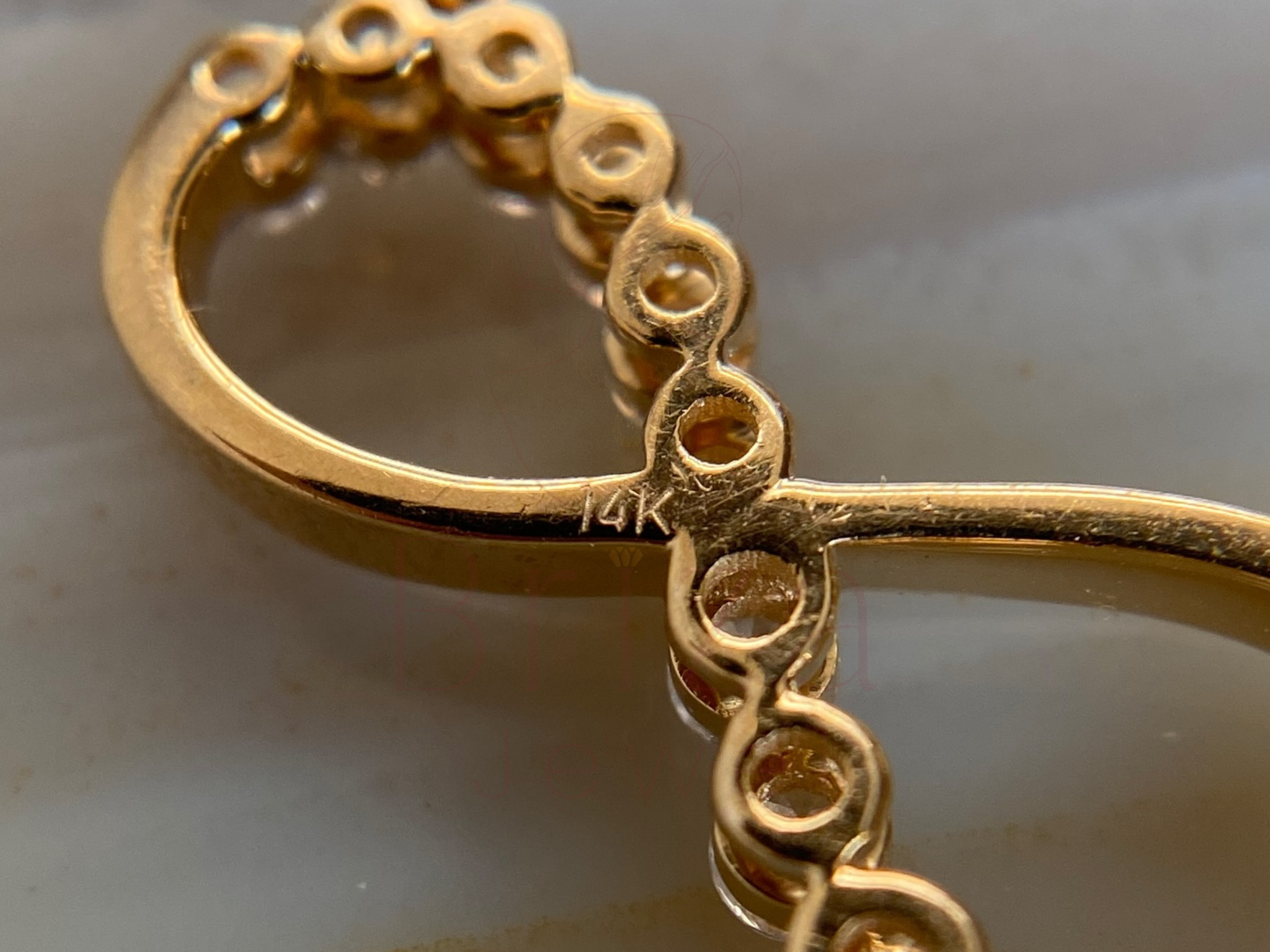 Close-up of a gold bracelet on a light background