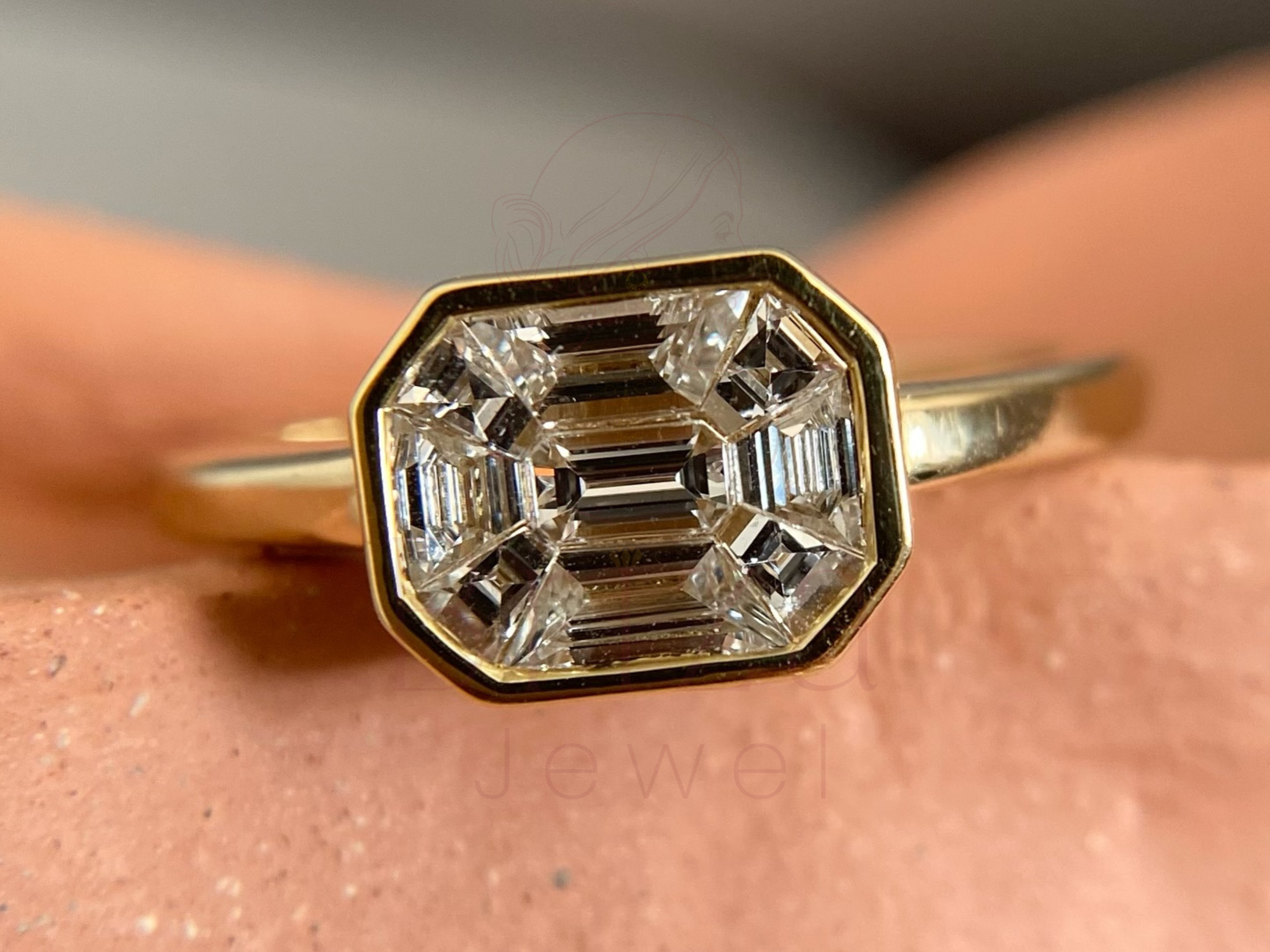 engagement ring with bezel setting featuring emerald cut diamond