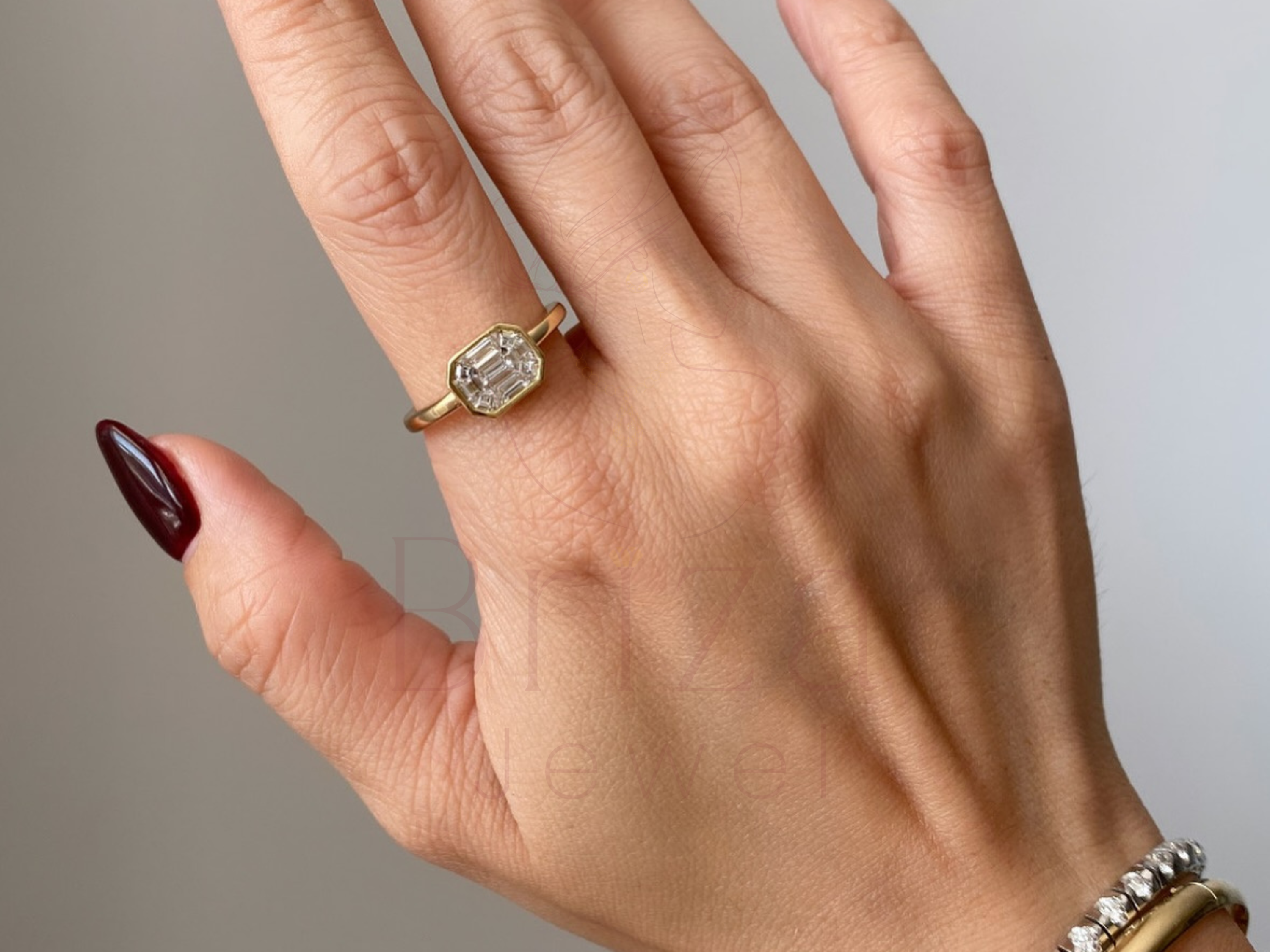engagement ring with bezel setting close-up of emerald cut stone