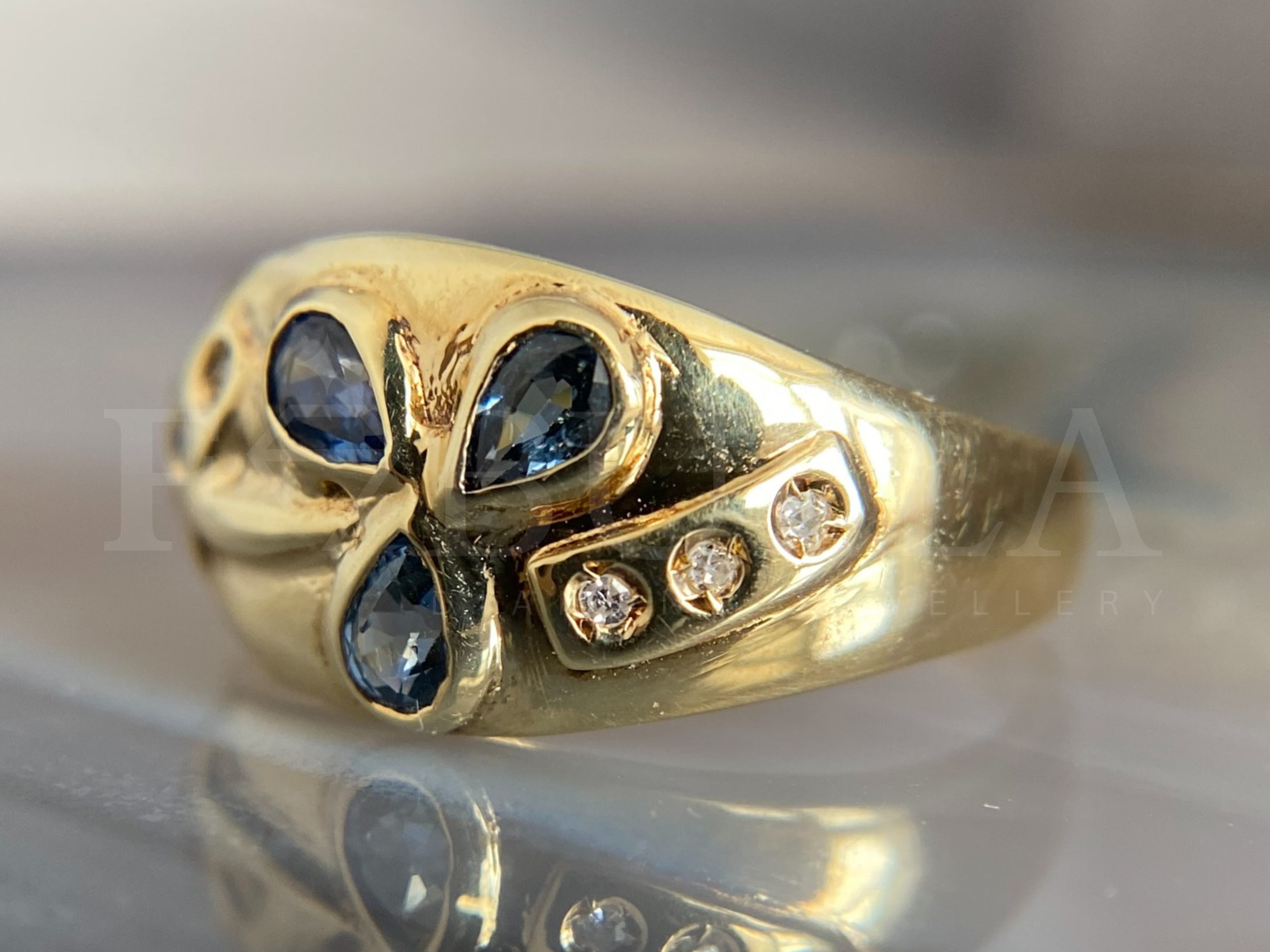 elegant sapphire cluster ring worn on hand lifestyle view