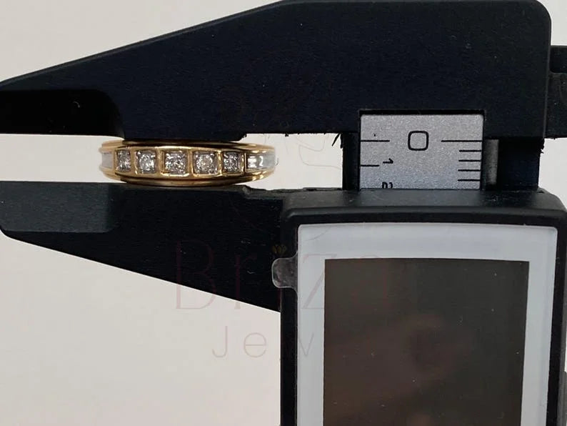 Gold ring with diamonds on a black stand with measurement scale