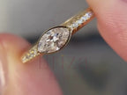 marquise cut diamond ring close-up showing pavé setting detail
