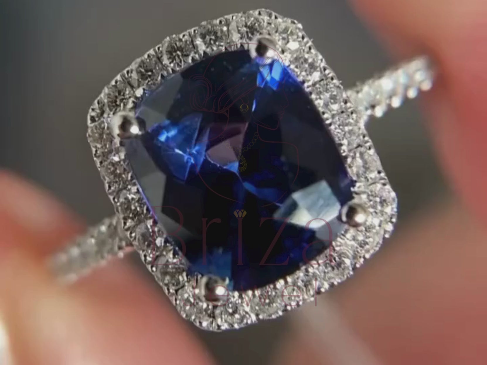 blue sapphire engagement ring close-up showing halo setting