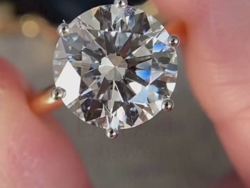 round diamond solitaire engagement ring close-up showing six prong detail
