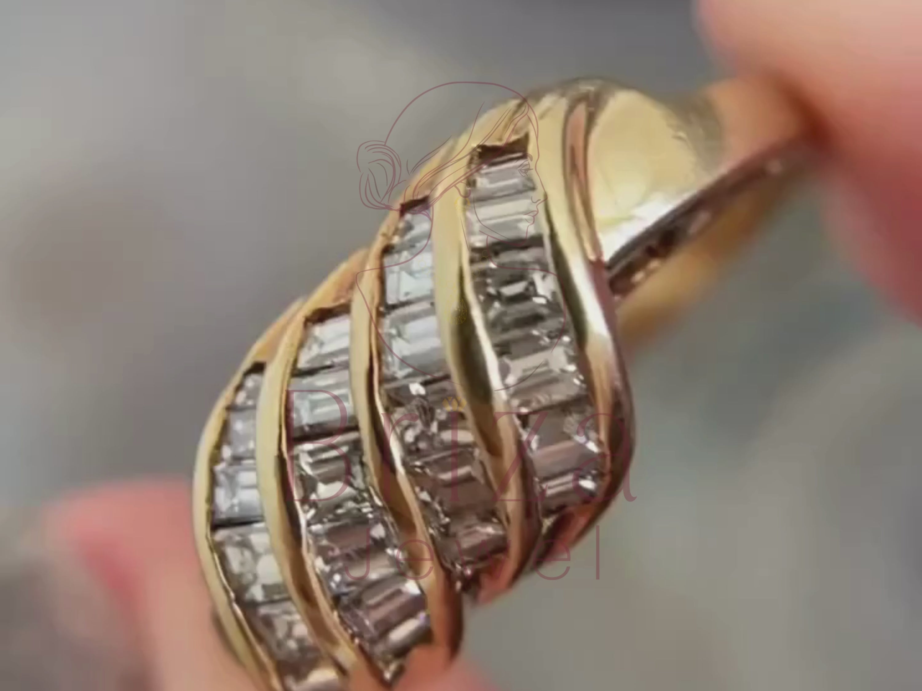 gold cocktail ring close-up showing baguette diamond wave