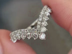 chevron engagement ring close-up showing curved diamond detailing