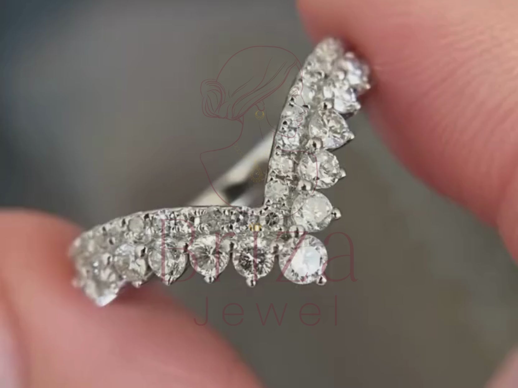 chevron engagement ring close-up showing curved diamond detailing
