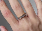 emerald and diamond ring close-up showing eternity setting