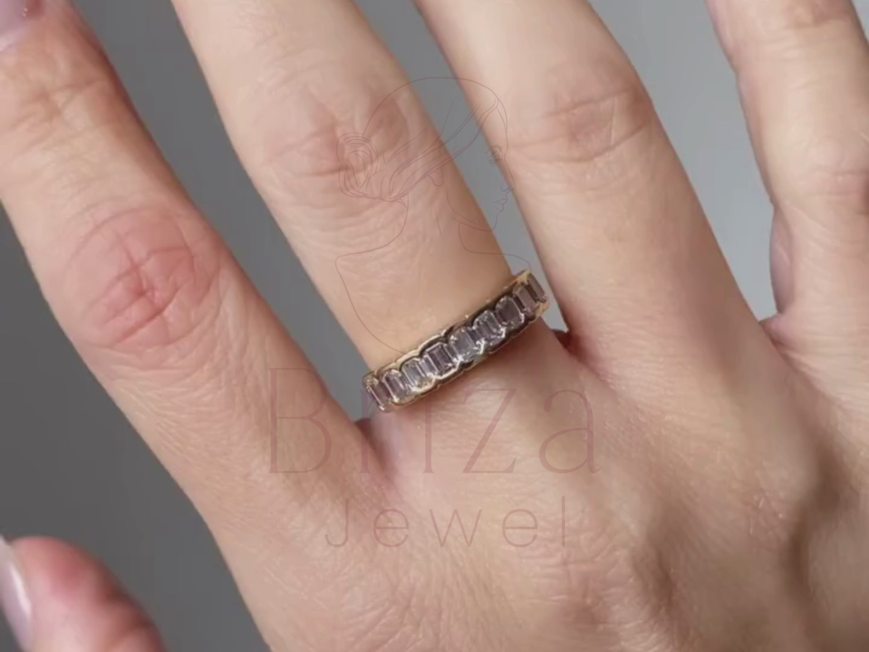 emerald and diamond ring close-up showing eternity setting