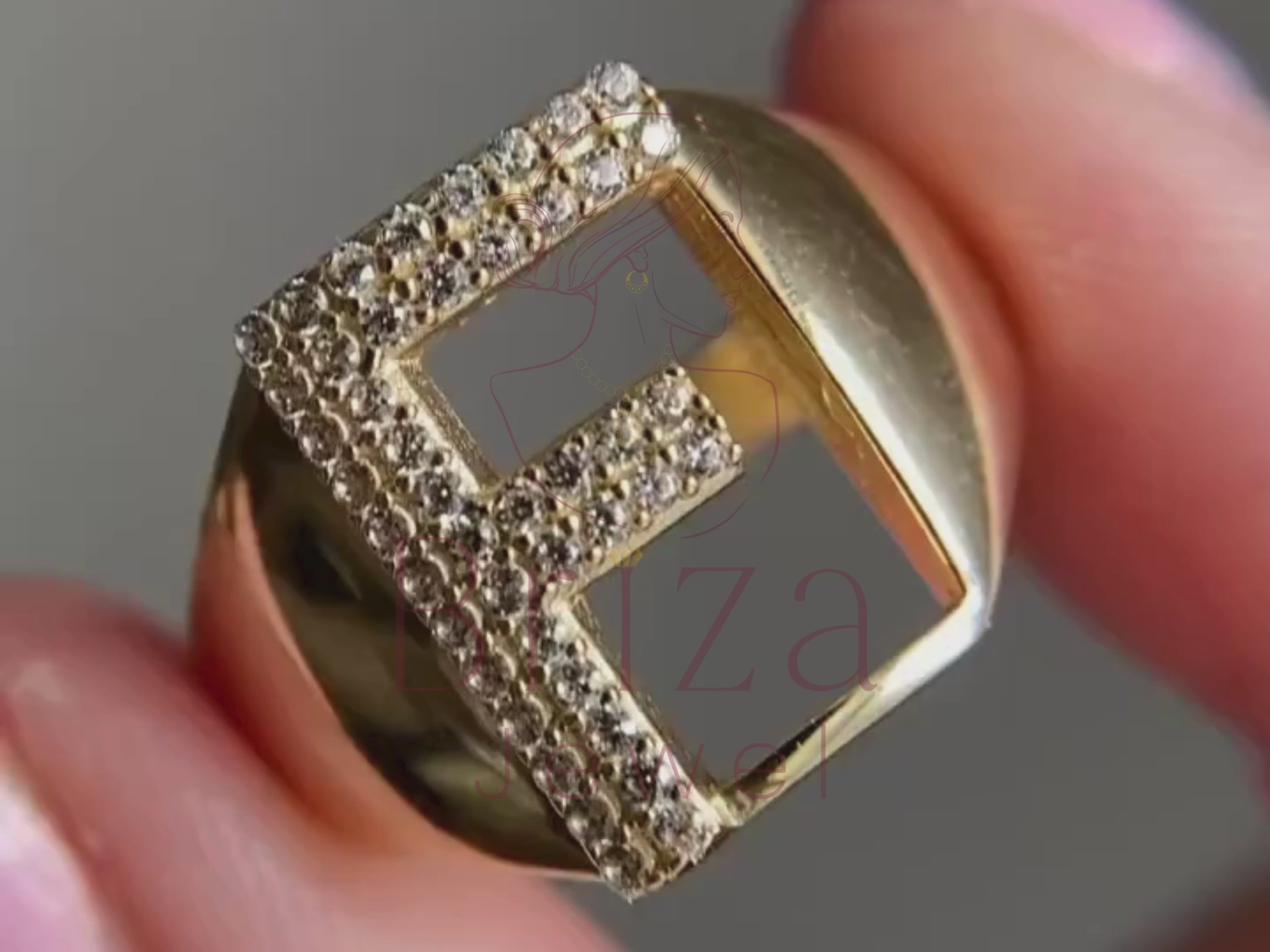 gold ring with initial close-up showing diamond letter detail
