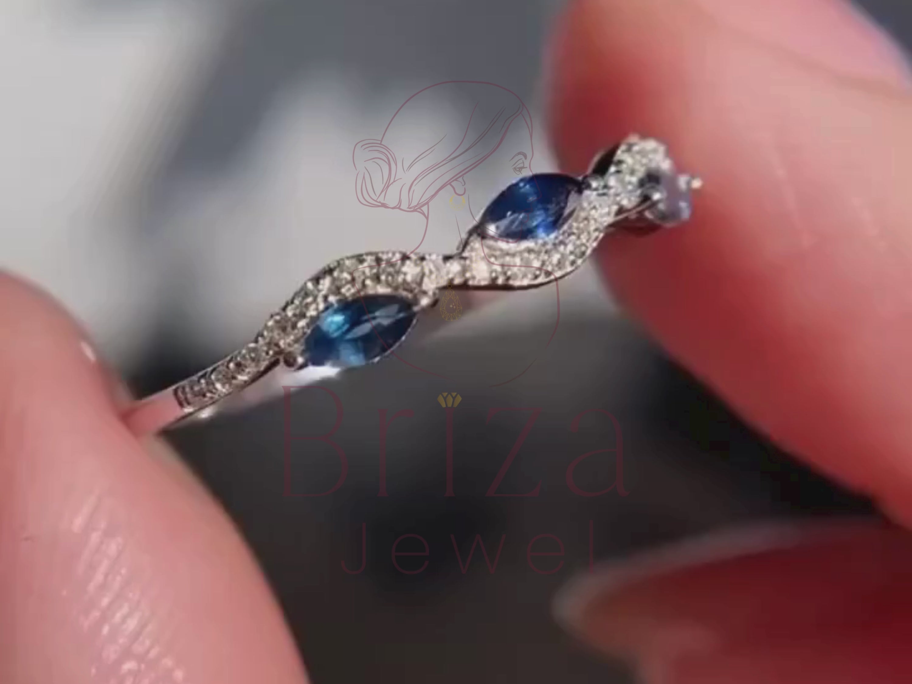 blue sapphire marquise ring close-up with diamond accents